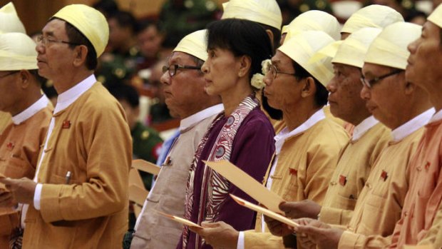 Aung San Suu Kyi and elected members of her National League for Democracy party take the oath of office yesterday.