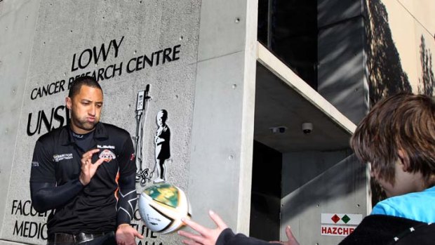 Taking time out ... Wests Tigers five-eighth Benji Marshall and 10-year-old cancer sufferer Hunter Jelicich pass a ball outside the Lowy Cancer Research Centre at the University of NSW at Randwick yesterday.