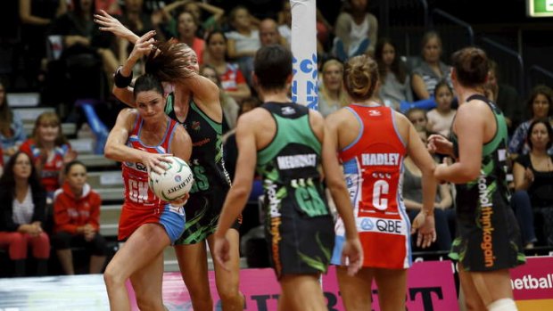 NSW Swifts recruit Sharni Layton grabs possession despite the efforts of the West Coast Fever defence.