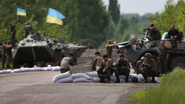 Ukranian military soldiers man a highway checkpoint near Slovyansk. At least 6 Ukranian soldiers were killed and more were reportedly injured by pro-Russian separatists in the nearby city of Kramatorsk.