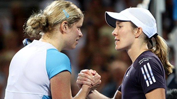 Belgian battle ... Kim Clijsters and Justine Henin meet at the net after their epic encounter in the Brisbane International women's final.