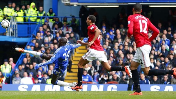 Chelsea's Demba Ba (left) scores against Manchester United during the English FA Cup quarter-final replay.