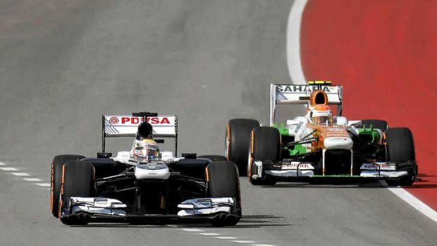 Williams driver Pastor Maldonado pulls ahead of Force India driver Adrian Sutil during qualifying for the US Grand Prix.