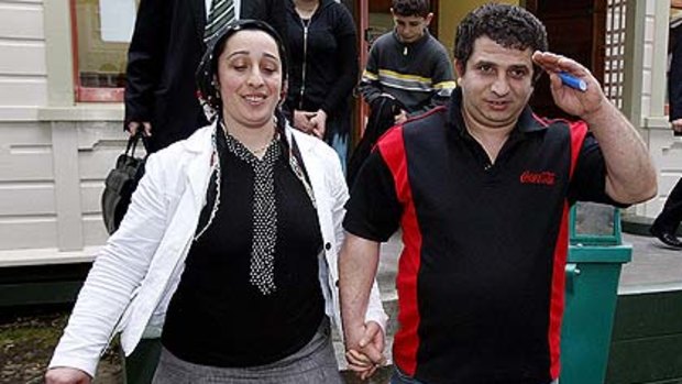 Allaetin Can and his wife, Elmas, leave the Hawera District Court after a hearing.