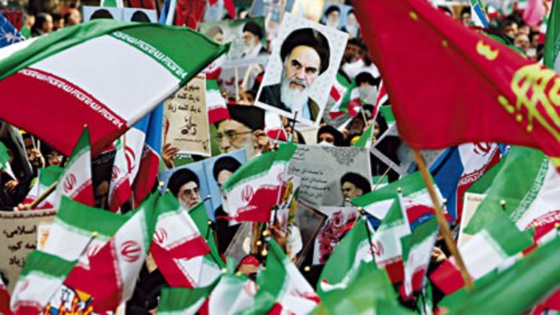 Young voices...Iranian schoolgirls at a rally marking the 30th anniversary of the seizure of the US embassy. The largest poster is of the late Ayatollah Khomeini.