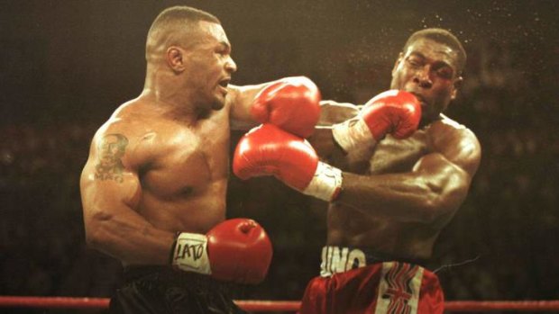 Mike Tyson lands a left on Frank Bruno in 1996.