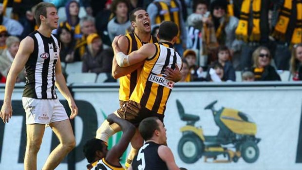 Hawks Lance Franklin and Clinton Young celebrate a Young goal against the Pies.