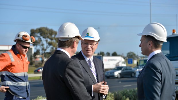 Victorian Premier Denis Napthine speaking with state Minister for Transport Terry Mulder and federal assistant minister for Infrastructure and Regional Development Jamie Briggs.