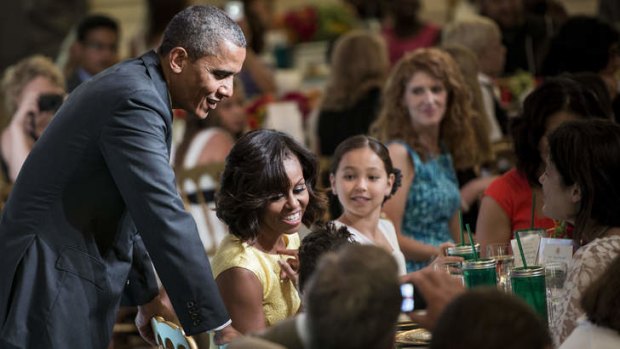 US President Barack Obama and US first lady Michelle Obama talk with guests during a kids' state dinner.