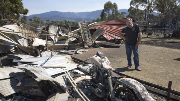 Mal Murdock surveys the damage to his property at Dunalley on the east coast of Tasmania  on January 5 after a bushfire ravaged the town last last night. His house was saved but he lost a Harley Davidson motorcycle a speed boat and his prized holden Monaro.