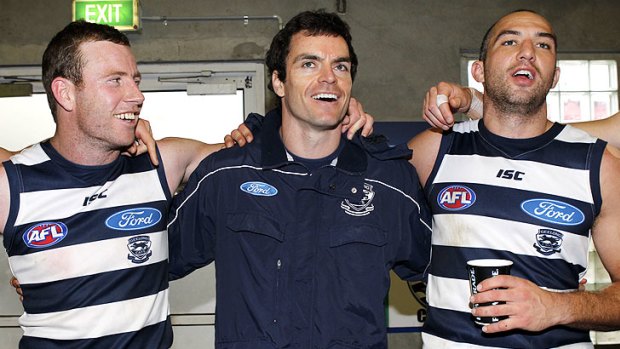 On song: Steve Johnson (left), Matthew Scarlett and James Podsiadly celebrate Geelong's 150-point win.