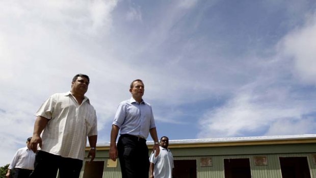 The full tour ... Federal Opposition leader, Tony Abbott takes a tour of the State House camp site, Menen. This site is currently a school but would be turned into a processing facility.
