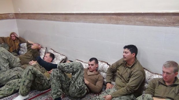 This picture released by the Iranian Revolutionary Guards shows the detained US Navy sailors at an undisclosed location.