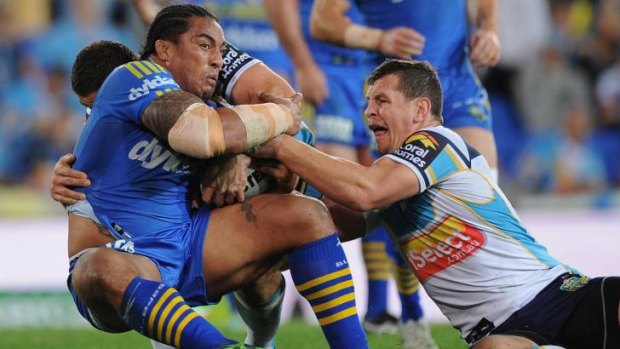 Brought down: Eels prop Fuifui Moimoi is tackled by the Titans.