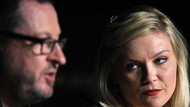 Best actress ... Kirsten Dunst looks on as Danish director Lars Von Trier addresses a press conference in Cannes before he was banned from the festival.