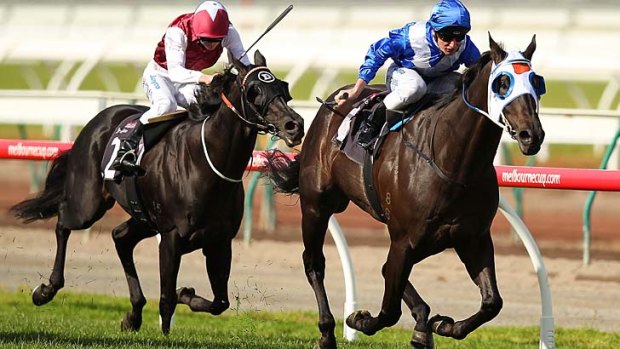 Sweet victory: Daniel Stackhouse rides Strawberry Boy to the line at Flemington on Saturday.