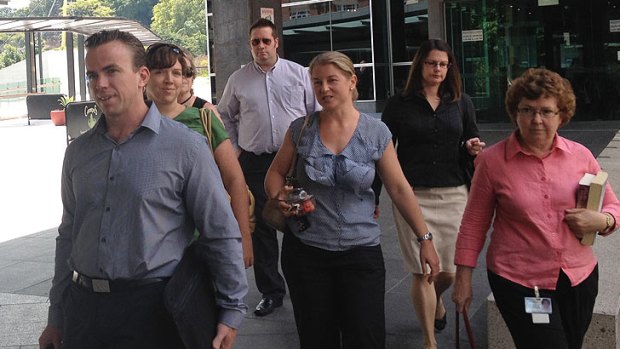 Senior Sergeant Mick Isles's family, led by Steven Isles (front), leave court.