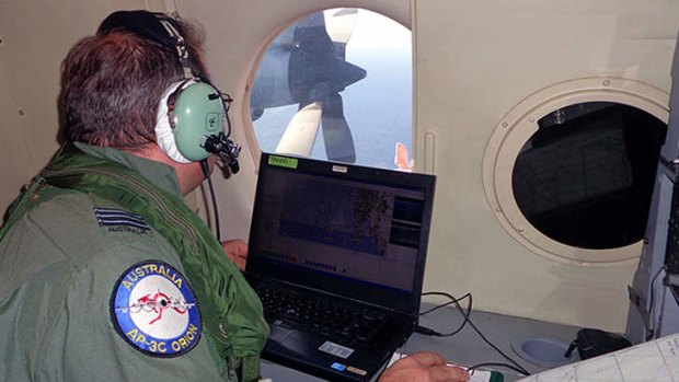 A crew member of an AP-3C Orion maritime patrol aircraft during a search operation for Malaysian Airlines Flight MH370 near Malaysia. Two RAAF Orions have begun searching 600,000 square kilometres of the remote Indian Ocean for the missing airline.