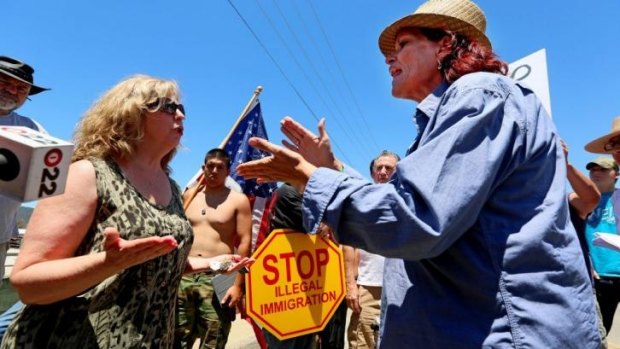 Pro- and anti-immigration protesters near the US border in Murrieta, California.