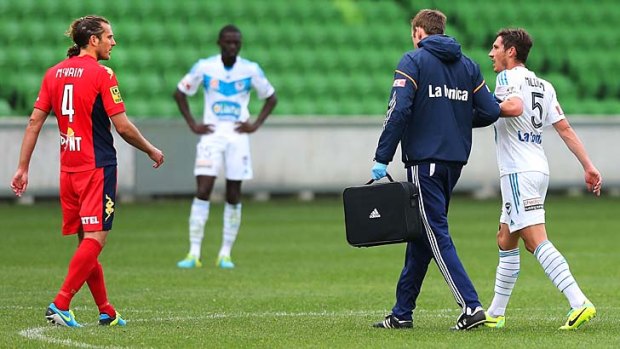 Mark Milligan leaves the ground injured during the pre-season match against Adelaide.