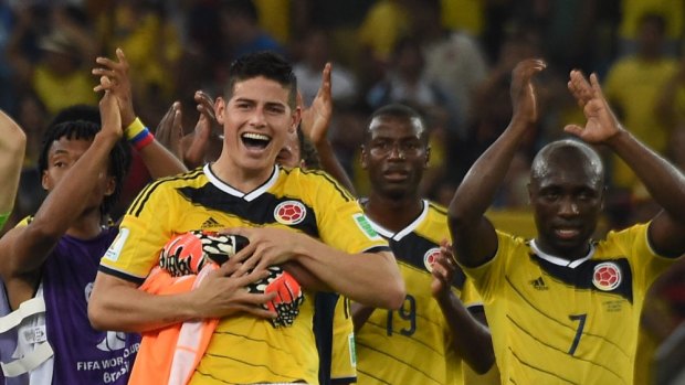 Good news for a nation ... Colombia's outstanding midfielder James Rodriguez and his teammates celebrate after defeating Uruguay 2-0 at the Maracana Stadium in Rio de Janeiro