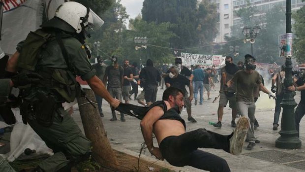 Greek protestors clash with riot police during a demonstration near Syntagma Square in the centre of Athens.