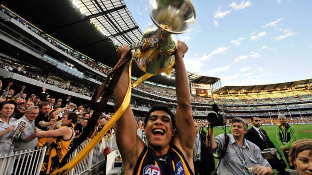 It's ours: Cyril Rioli with the premiership cup after Hawthorn defeated Geelong in the 2008 grand final.
