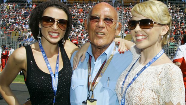 Fell down a lift shaft ... formula one legend Stirling Moss, pictured here with Dannii, left, and Kylie Minogue in Melbourne in 2007, has been seriously injured.