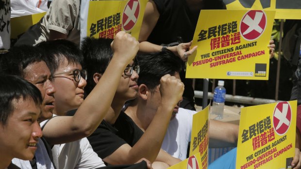 Pro-democracy protesters celebrate after lawmakers voted against the electoral reform proposals in Hong Kong.