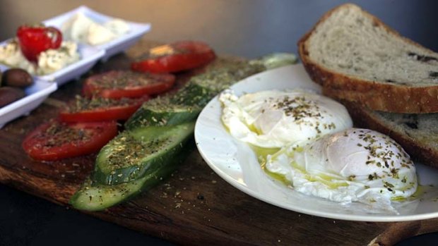 Mediterranean breakfast ... two poached free range eggs, natural yoghurt, fresh tomatoes, Persian fetta, kalamata olives and cucumbers served with organic olive bread.