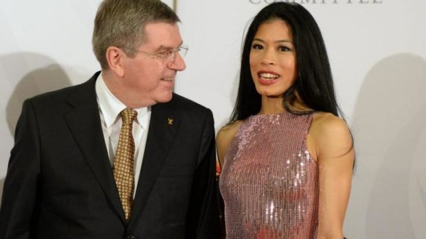 President of the International Olympic Committee Thomas Bach chats with Vanessa Mae at the IOC Gala Dinner in Sochi.