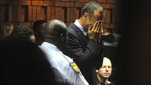 Remanded in custody ... Oscar Pistorius weeps in court in Pretoria.