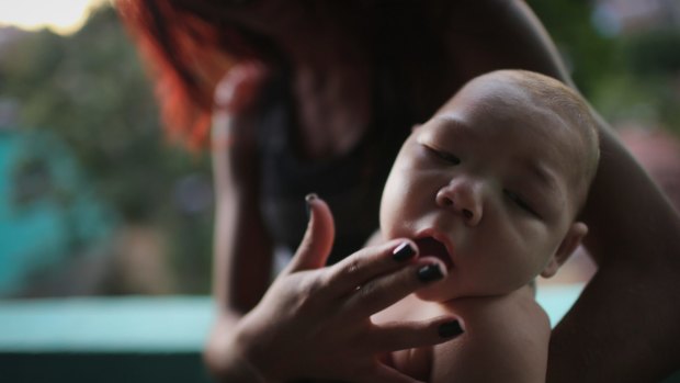 Estafany Perreira holds her five-month-old nephew David Henrique Ferreira, who has microcephaly. 