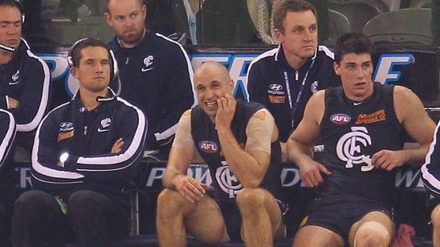 What have I done? Chris Judd watches from the bench.