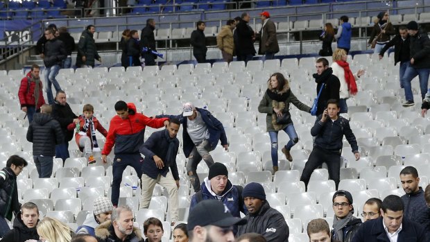 Soccer fans move towads the grounds at the Stade de France after explosions were heard during the friendly match between France and Germany. 