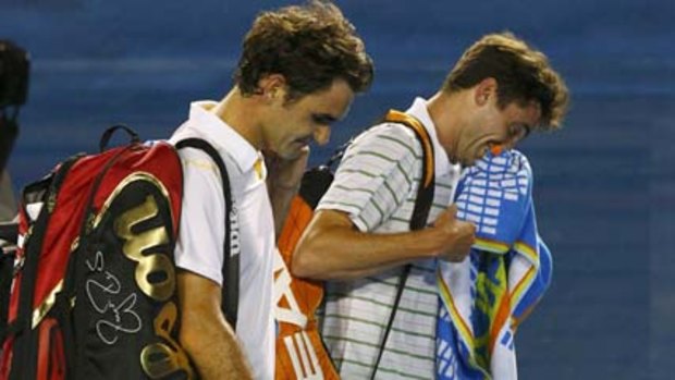 Clash of styles ... Roger Federer, left, and Gilles Simon.
