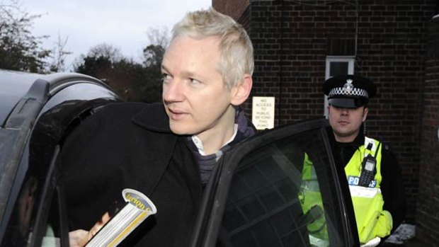 Julian Assange visits a police station as part of his bail terms.