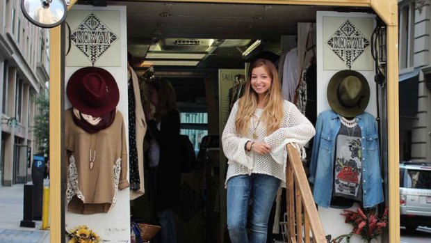 Jessie Goldenberg poses in the entrance of her fashion truck, Nomad.