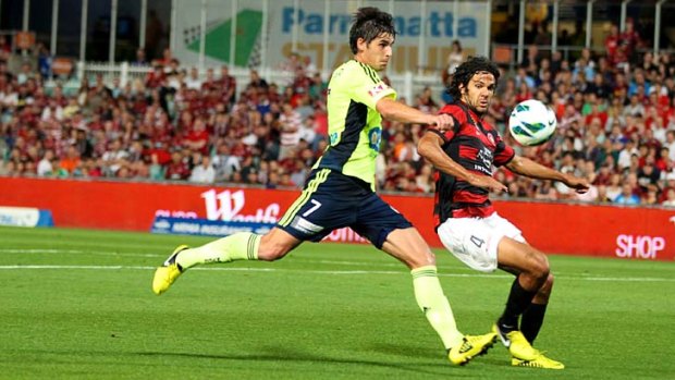 Willing contest ...  Wanderers defender Nikolai Topor-Stanley tries to cut off Melbourne Victory midfielder Guilherme Finkler’s path towards goal on Saturday.