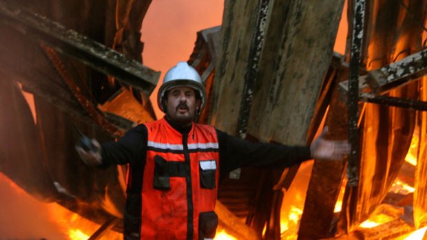 A firefighter outside the burning UN headquarters in Gaza today.