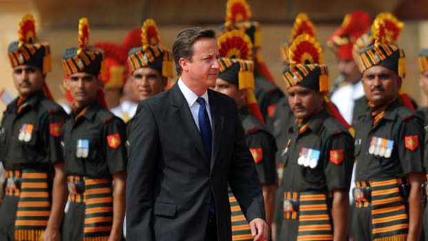British Prime Minister David Cameron inspects an honour guard at the Presidential Palace in New Delhi.