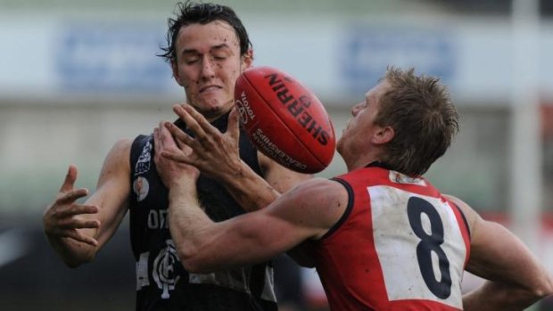 Ball up: Jarryd Coulson of the Blues attempts to mark as Casey’s Troy Davis moves in. 