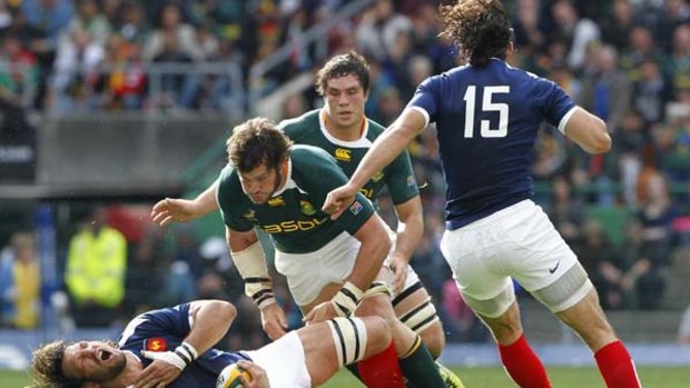 France's Lionel Nallet grimaces after being tackled by South Africa's Danie Rossouw.