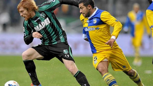 Davide Biondini of Sassuolo keeps possession against Walter Gargano of Parma.