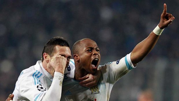 Olympic Marseille's Andre Ayew celebrates after scoring against Inter Milan.