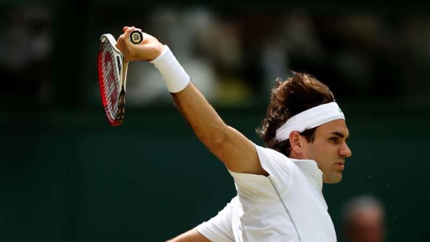 Green machine &#8230; Roger Federer hits a backhand as he cruises to victory against Mikhail Youzhny at Wimbledon.