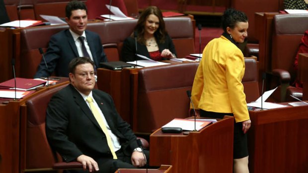 PUP Senator Jacqui Lambie takes her seat along with colleague Glenn Lazarus, right, and, behind, Greens senators Scott Ludlam and Sarah Hanson-Young. Senator Lambie has had her first meeting with Prime Minister Tony Abbott.