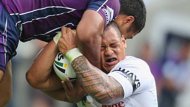 It's mine: Dragons back-rower Leeson Ah Mau battles for possession against the Storm.