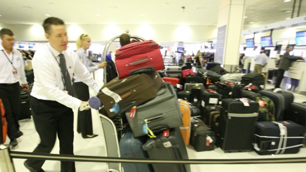 Delays during strike ... baggages pile up at Sydney Airport's international terminal.
