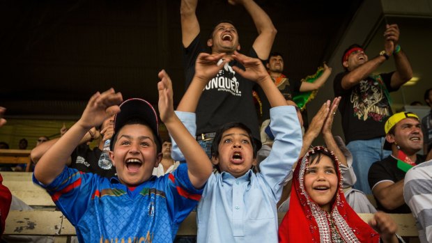 Local Afghani fans support  their cricket team in the World Cup warm-up match in Melbourne.
